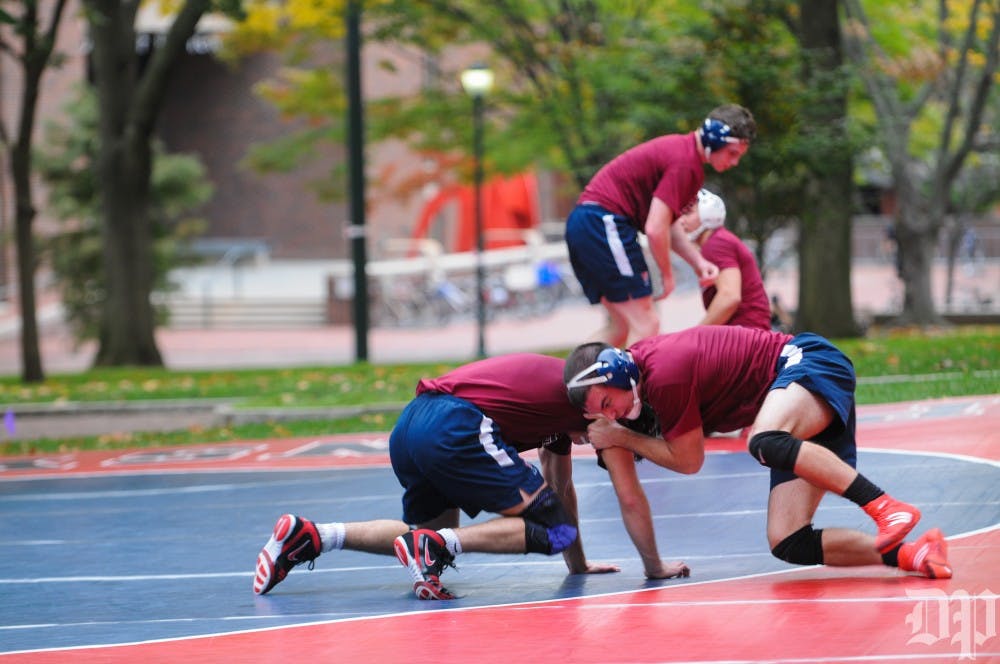 In Penn wrestling's first time outdoor practice, senior Caleb Richardson is seen grappling right outside College Hall. He looks to hit all-America status in 2017.
