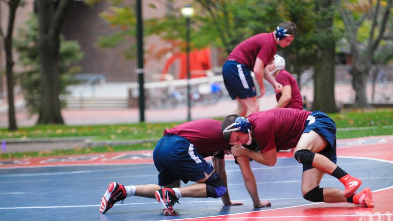 In Penn wrestling's first time outdoor practice, senior Caleb Richardson is seen grappling right outside College Hall. He looks to hit all-America status in 2017.