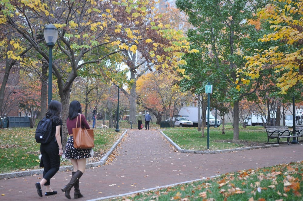 Students walked past by the High Rise Fields, where&nbsp;trees showed&nbsp;signs of autumn.
