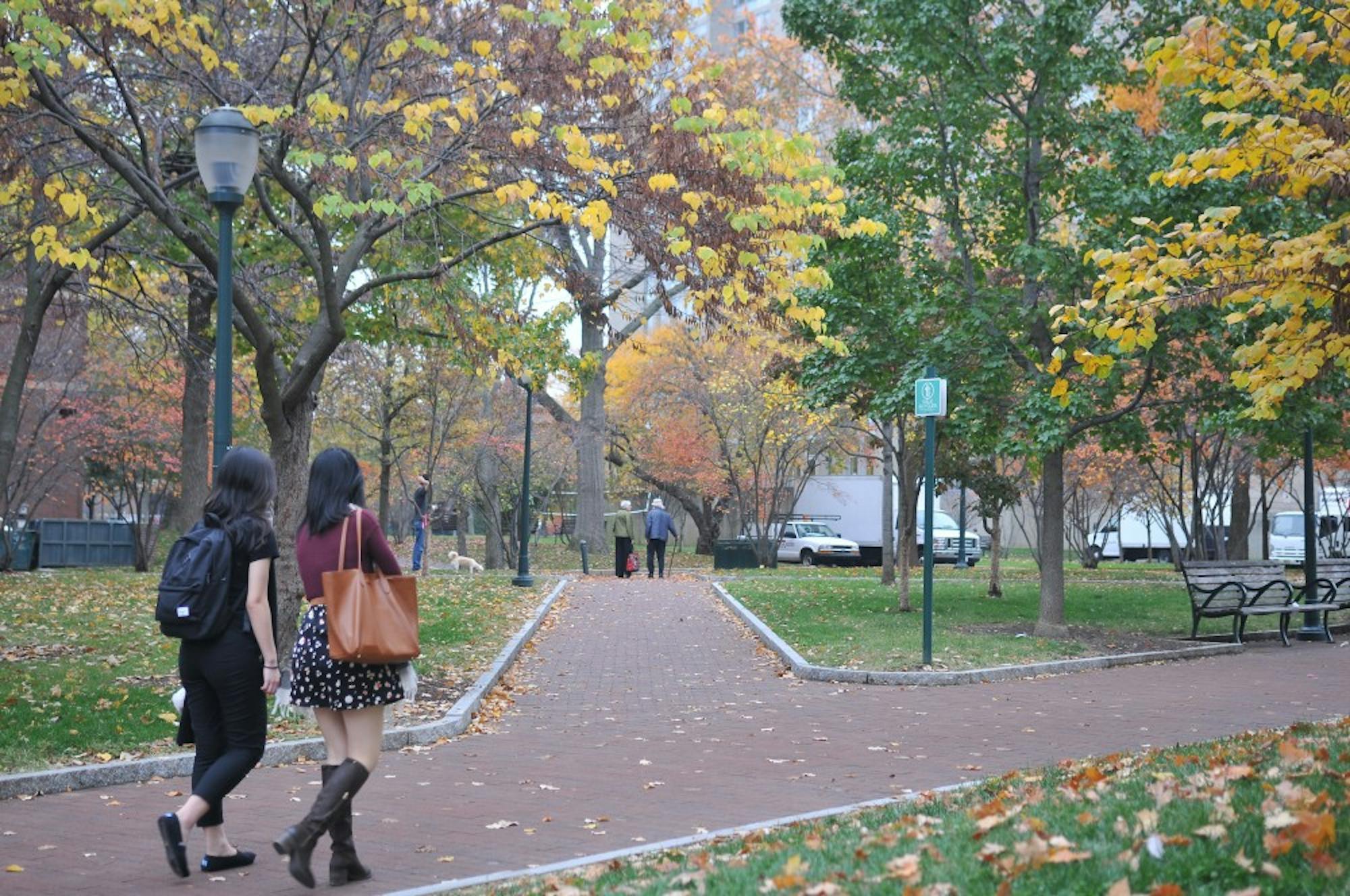 Students walked past by the High Rise Fields, where&nbsp;trees showed&nbsp;signs of autumn.