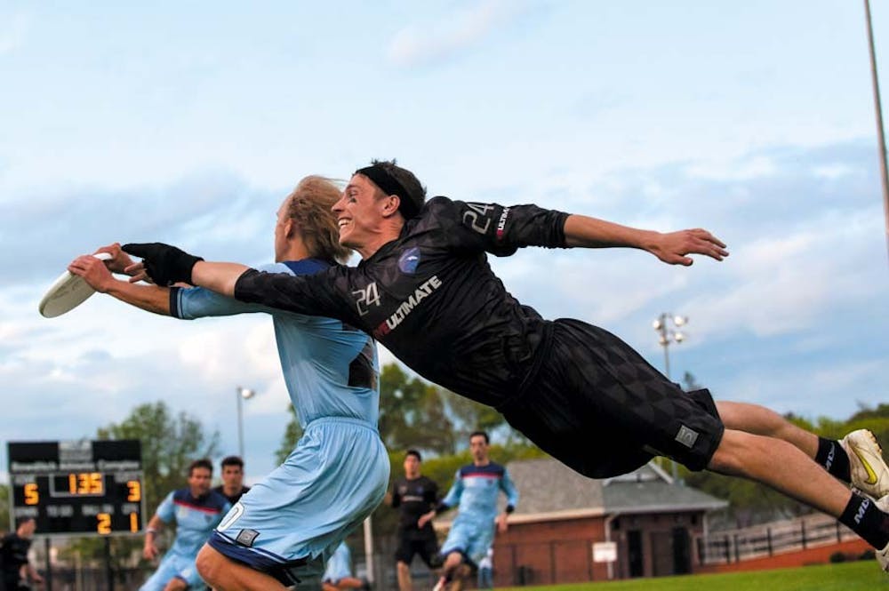 The Whitecaps' Alex Simmons with the defensive bid against David Baer. The Boston Whitecaps defeated the Philadelphia Spinners 22-18 in a Major League Ultimate Game at Bowditch Field in Framingham, MA on May 18th, 2013. © Marshall Goff for Ultiphotos.