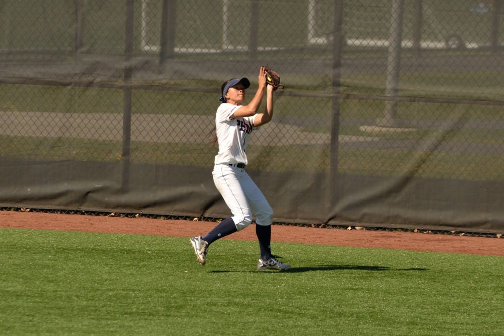 Senior Kanani Datan catches a fly ball in the outfield. 