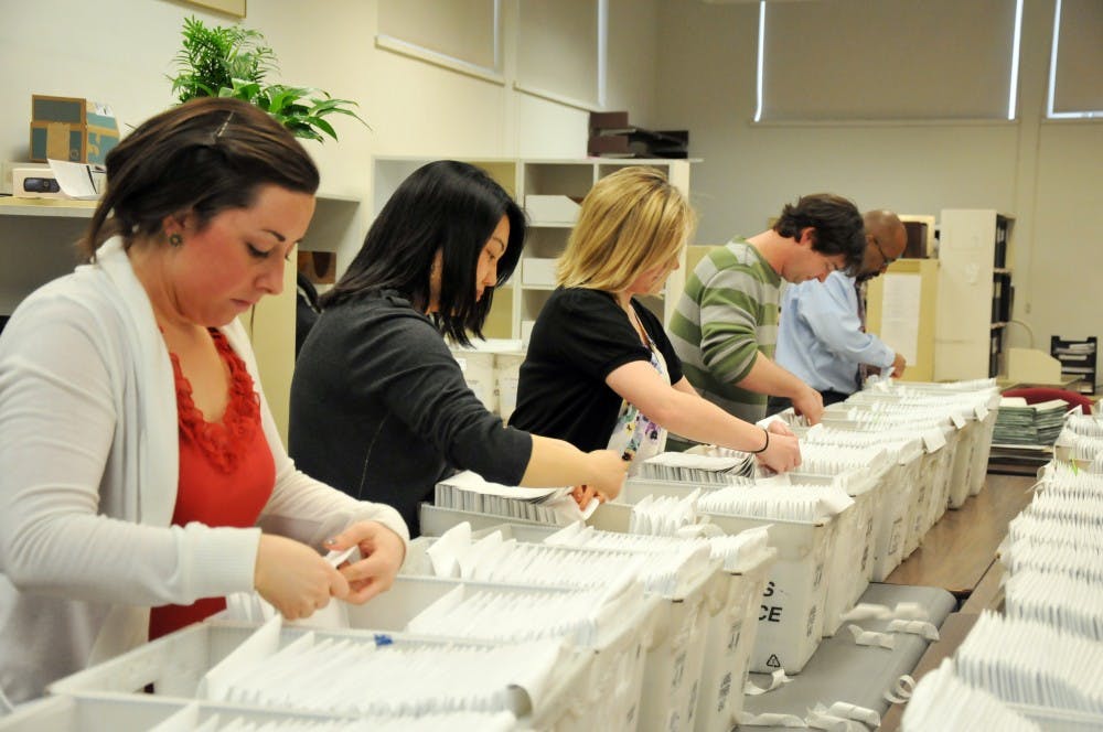 Eric Furda and others in the Admissions office seal acceptance letters to be mailed to students in the class of 2015