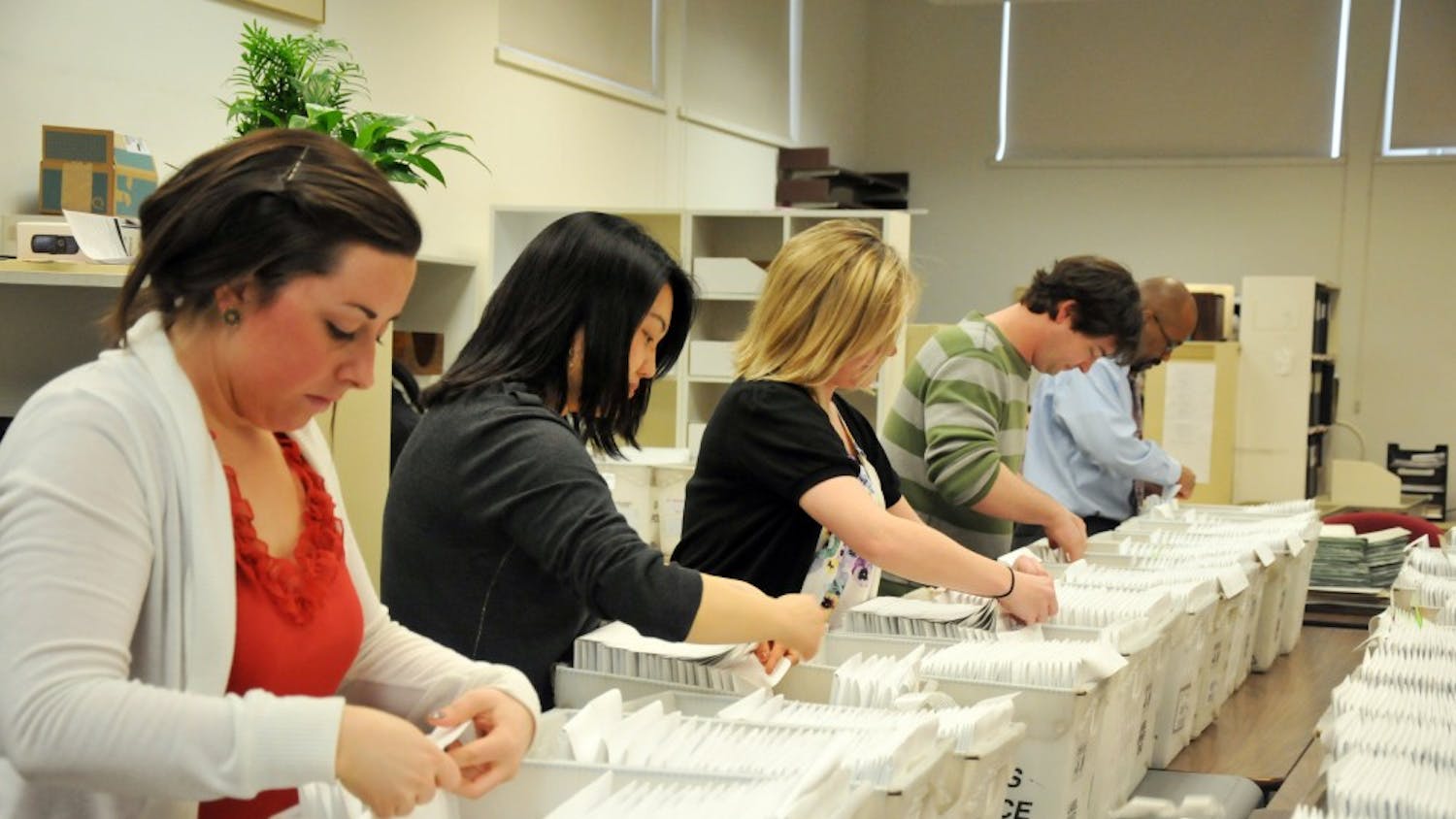 Eric Furda and others in the Admissions office seal acceptance letters to be mailed to students in the class of 2015