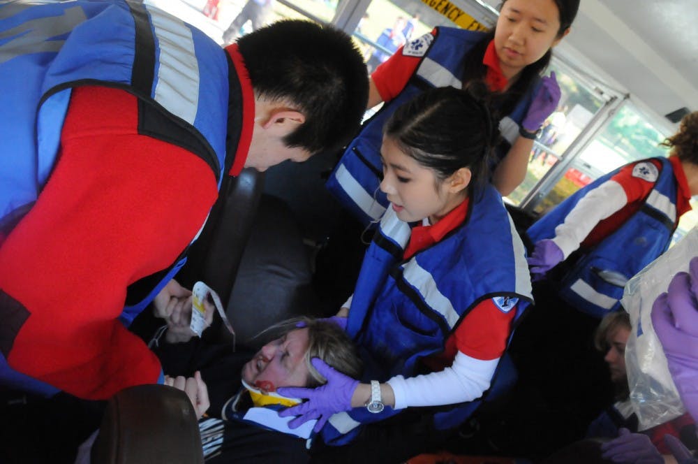 	MERT members respond to simulated mass casualty incident of a car and bus collision. The injured wore makeup and fake lacerations to make the simulation more realistic.