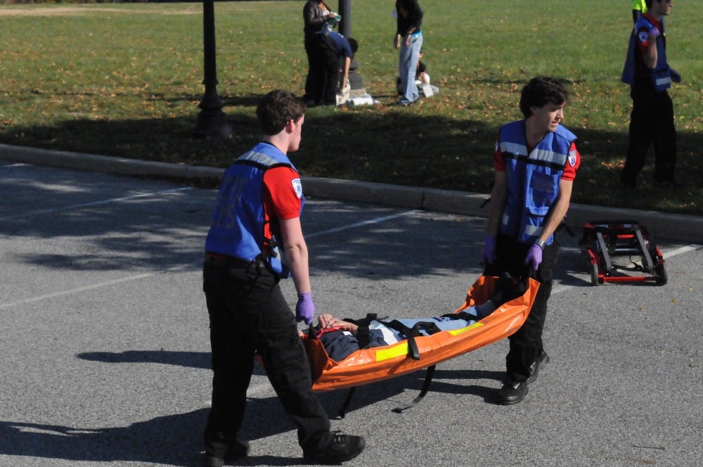 	MERT members respond to simulated mass casualty incident of a car and bus collision. The injured wore makeup and fake lacerations to make the simulation more realistic.