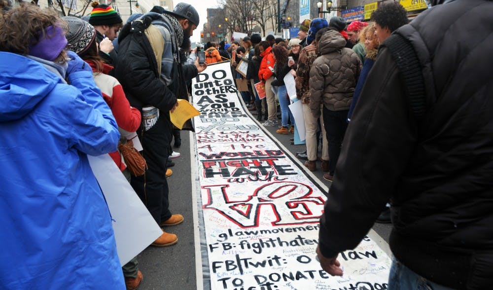 People carried a 30 feet long sign that promotes love and the "golden rule."