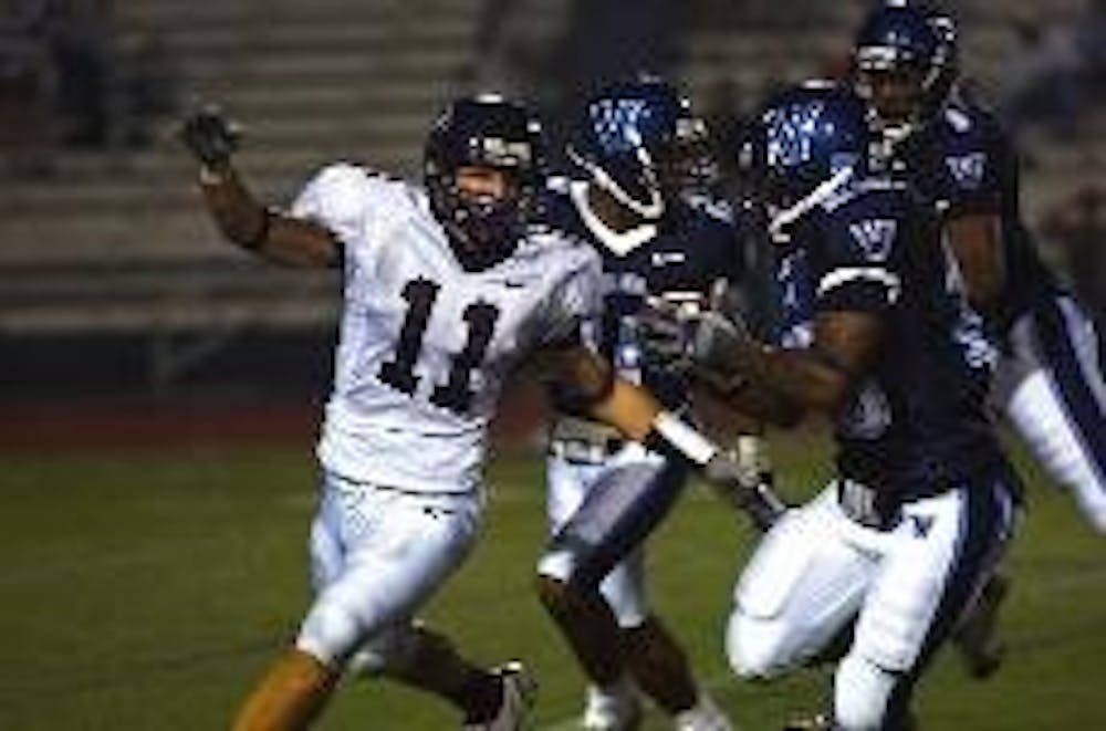 Football Notebook | Teammates ogle Maugle's visor