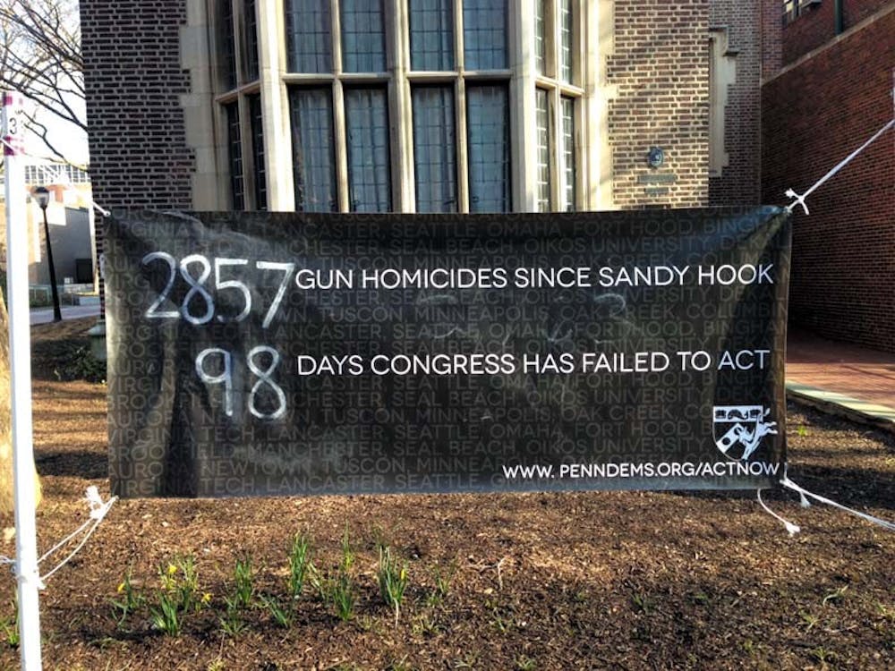 	Penn Democrats’ banner on Locust Walk counts the number of gun homicides since the mass shooting at Sandy Hook Elementary School and the number of days without Congressional action on gun control.