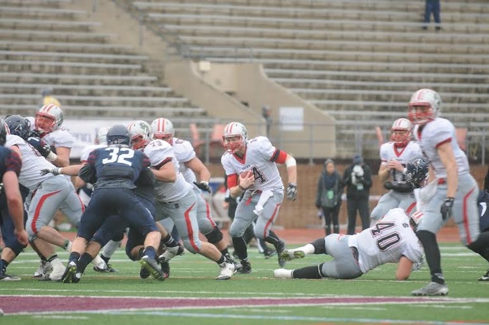 Brown backup quarterback Seth Rosenbauer looks for daylight while picking up a chunk of his 206 rushing yards that he amassed against Penn in a 21-13 Bears win.