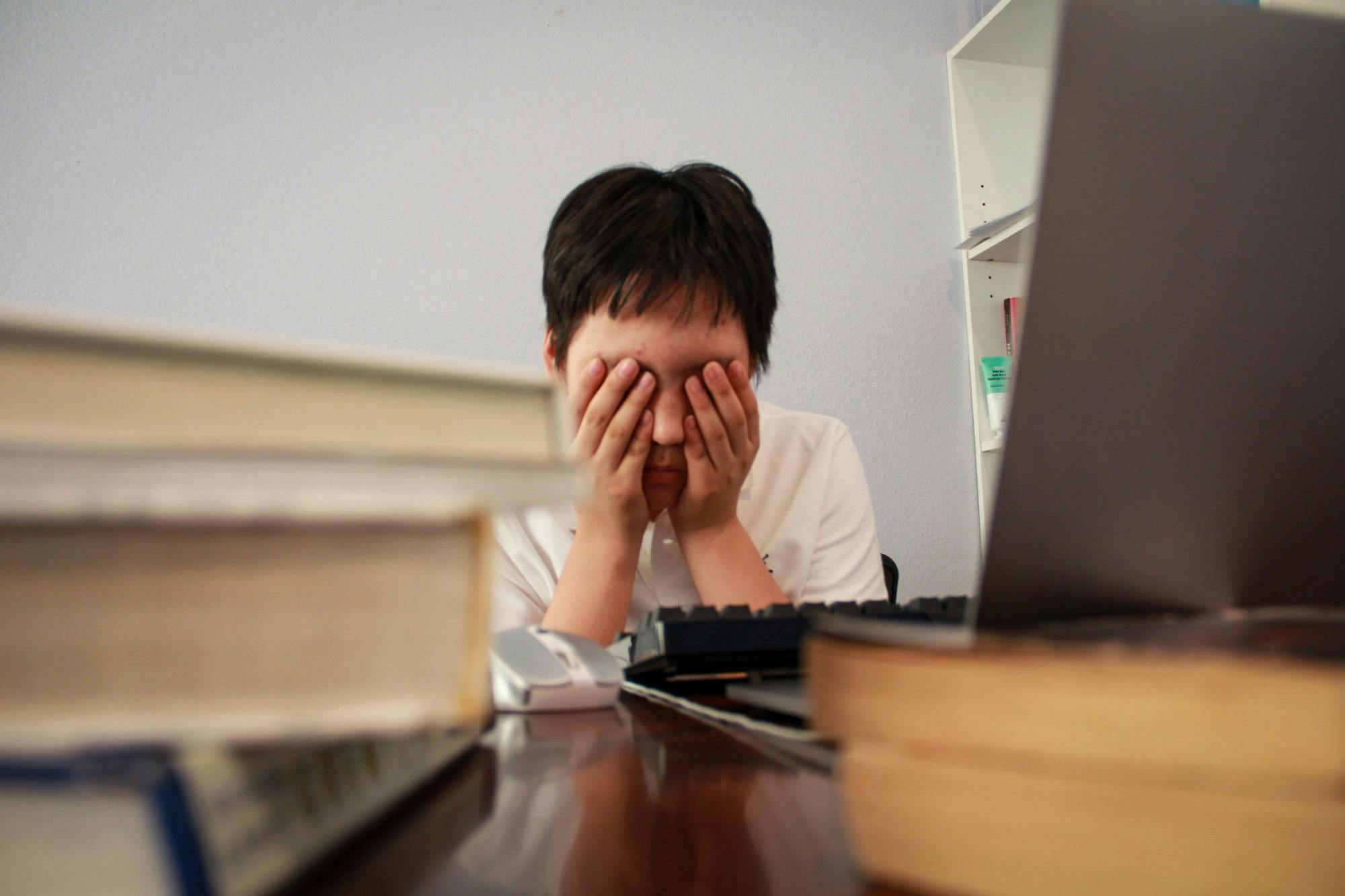 Stressed Student Homework Studying Textbooks Online Learning Virtual Instruction.JPG