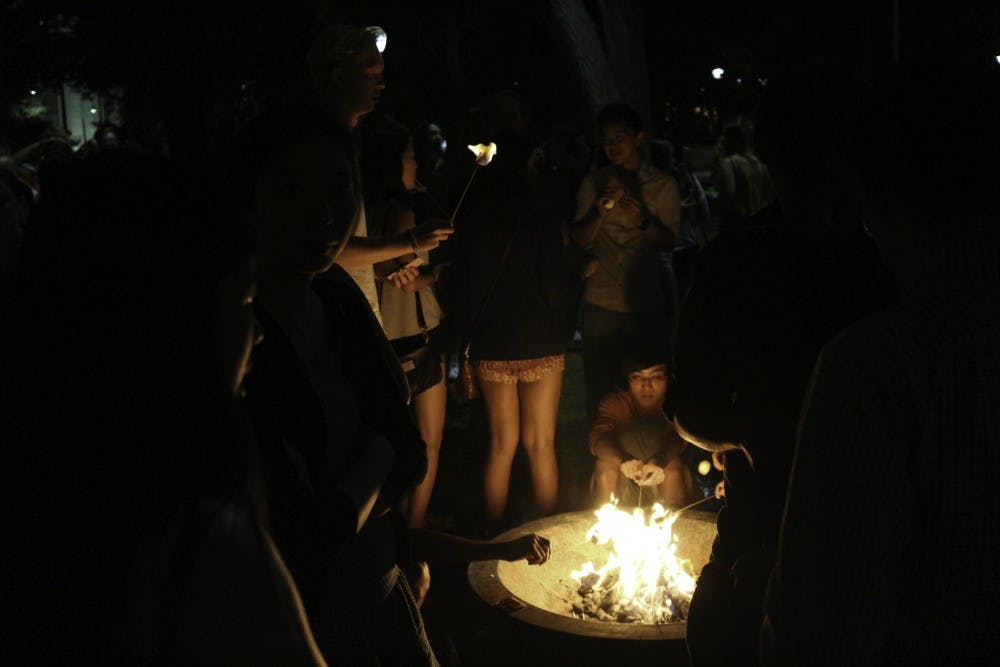 Friday: Penn Outdoors Club cooks s'mores in front of The Button.
