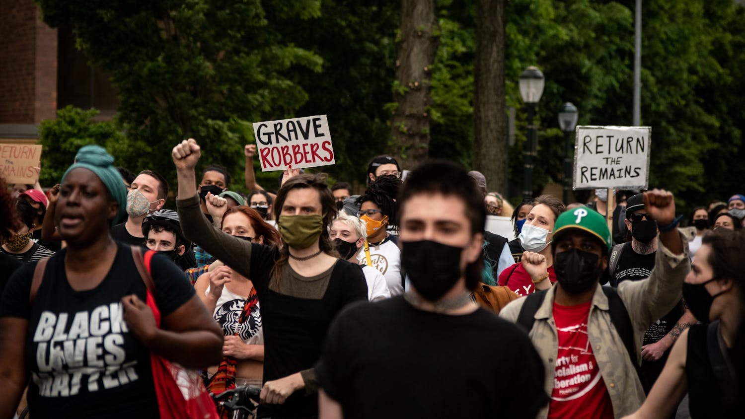 4-28-21 Protest MOVE Bombing Grave Robbers Sign (Max Mester).jpg