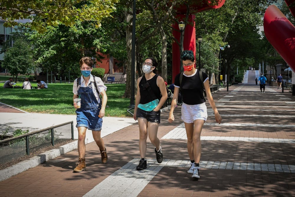 students-walk-outside-locust-walk-sunshine-masks-pandemic-sukhmani-kaur