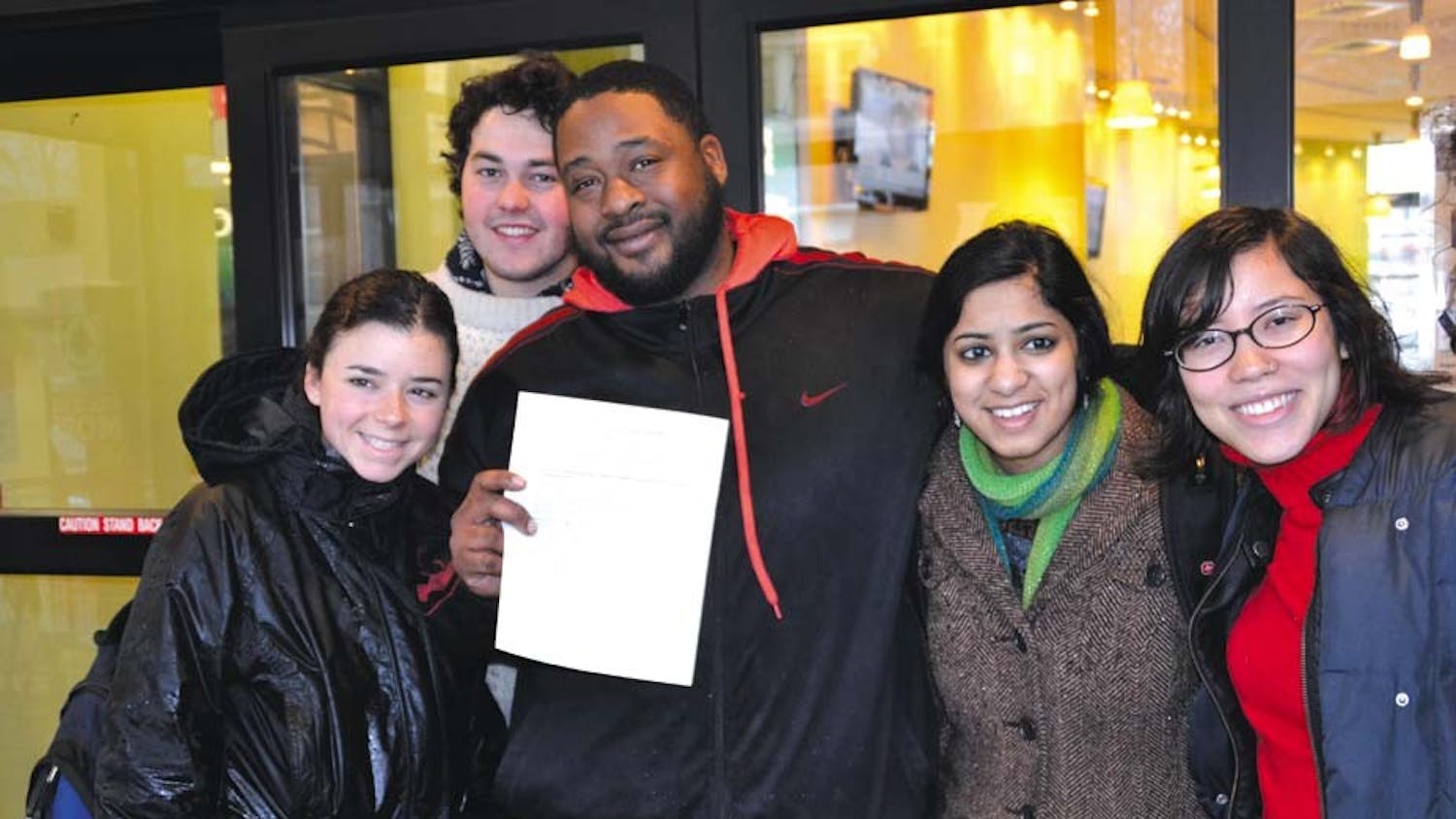 (From left to right) College senior Erica Kimmel, College sophomore Brendan Van Gorder, dining hall worker Kareem Wallace, College senior Meghna Chandra and College sophomore Chloe Sigal drop off a letter with Business Services.