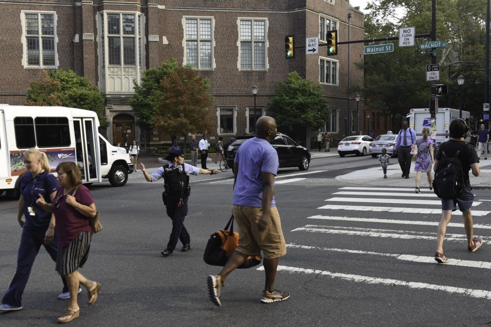 (Choice 1/3) Wednesday: A Penn Police officer directs traffic during rush hour.