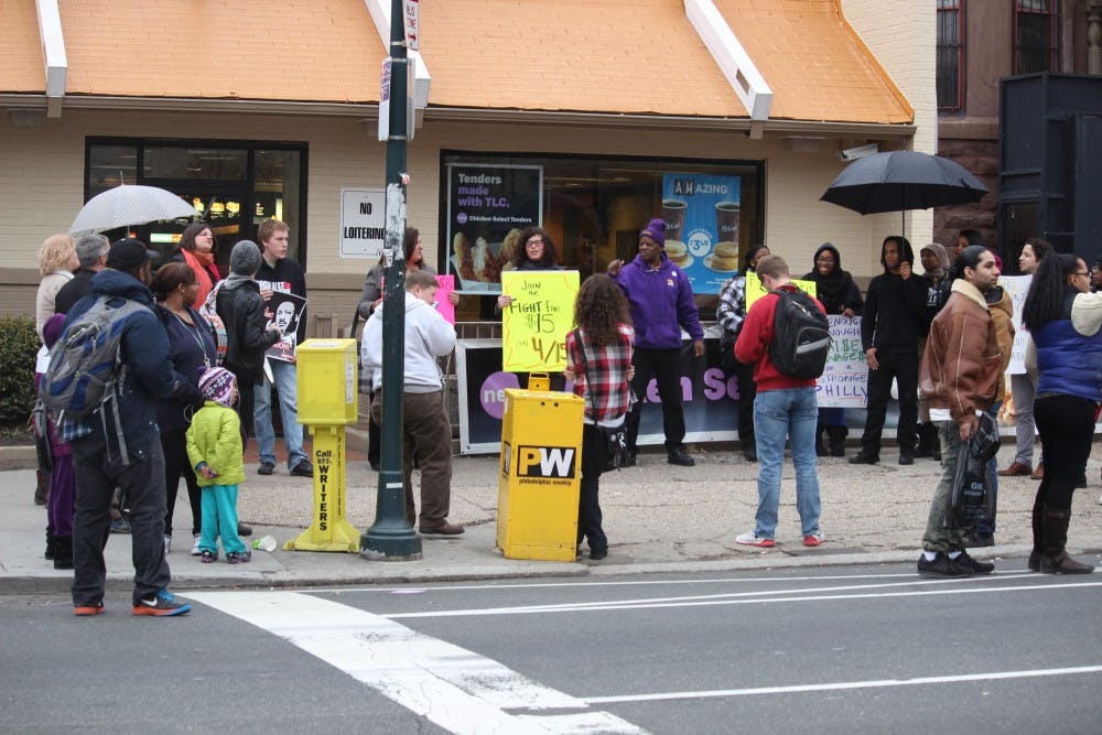 Supporters and workers held signs and chanted outside of the McDonald's at 40th and Walnut on Tuesday.