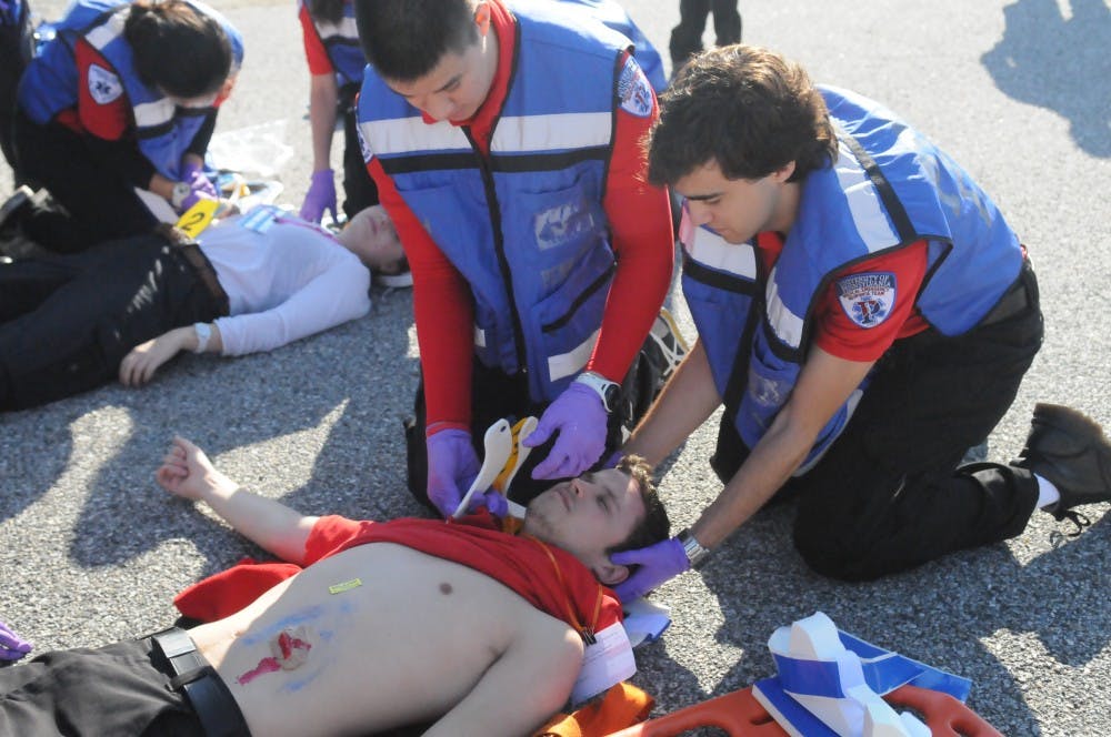 	MERT members respond to the mass casualty incident of a car and bus collision. The injured wore makeup and fake lacerations to make the simulation more realistic.