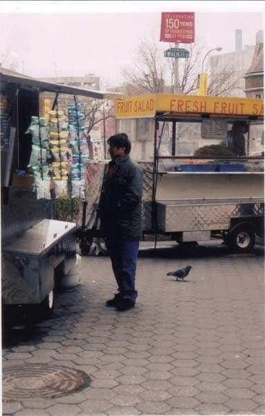 	Don Ly stands by his fruit truck at 34th and Walnut streets years ago.