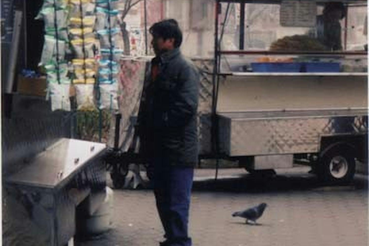 Don Ly stands by his fruit truck at 34th and Walnut streets years ago.