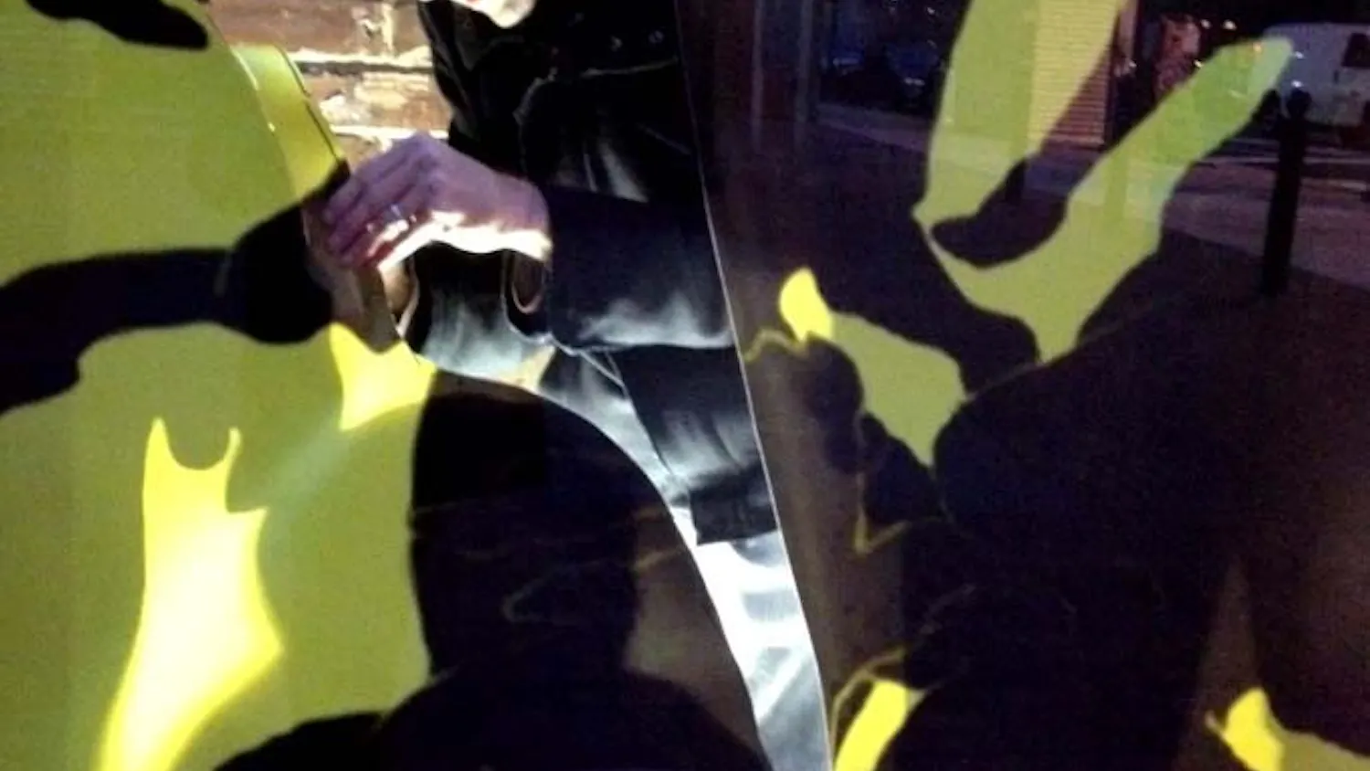 Second-year School of Design graduate student Daniel Oliva installs his piece on the Addams Family Silhouette. The installation will be removed Dec. 19.