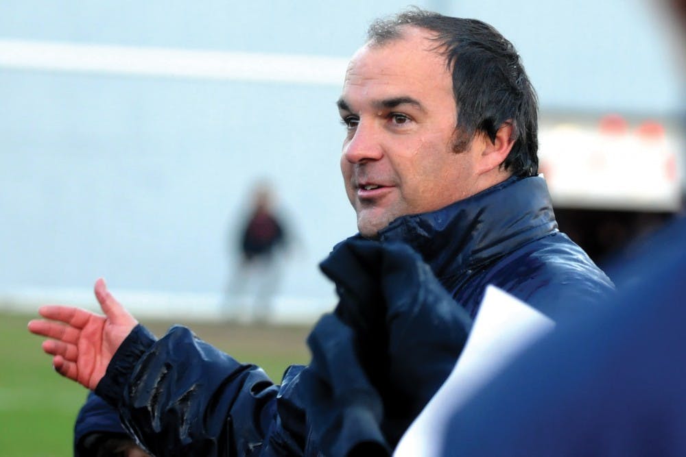 Men's soccer plays Harvard for the Ivy League title and comes out victorious.A wet Rudy Fuller congratulates his Ivy championship team