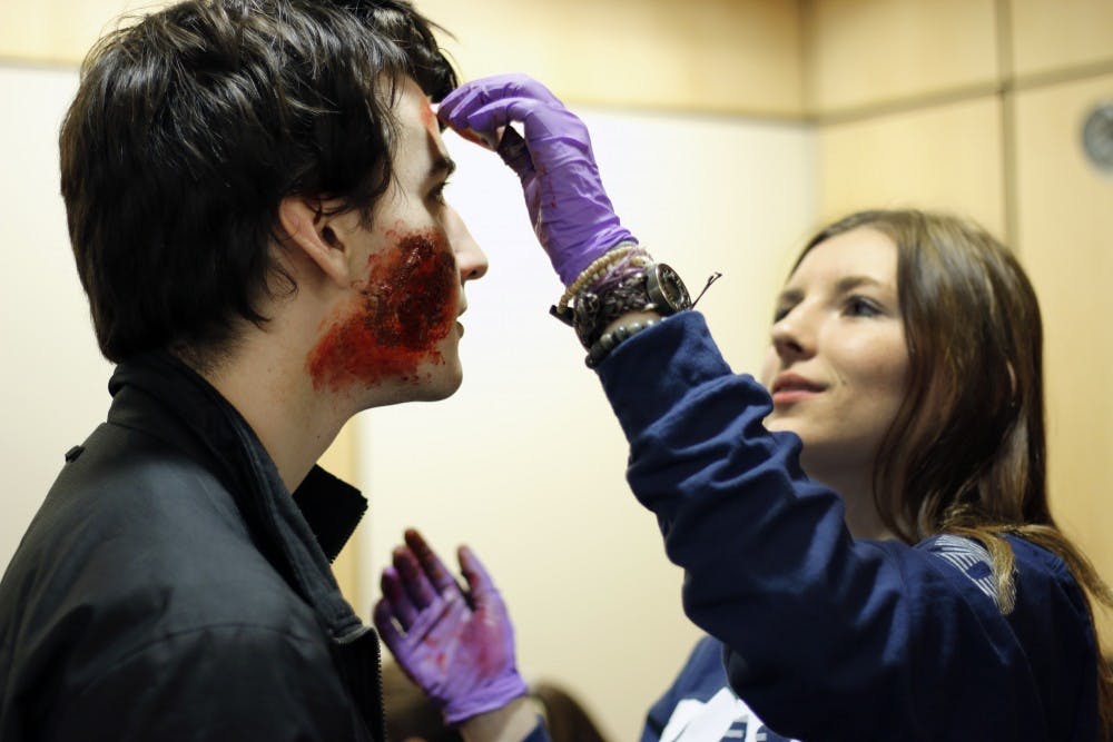 Wharton freshman Jessy Sandoval (right) applied makeup to MERT Mass Casualty Incident Drill participants on Sunday.