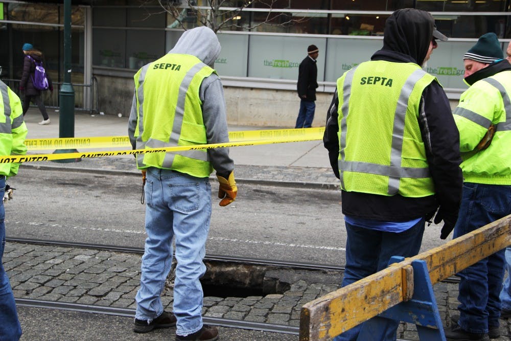 SEPTA officials addressed a sinkhole in front of Jake's Sandwich Board early Friday afternoon | Photo Manager Carson Kahoe. 