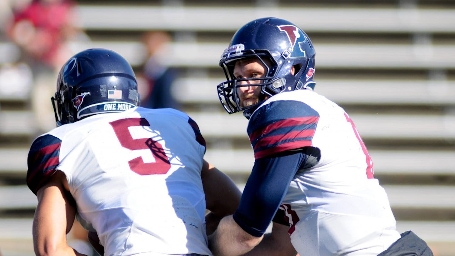 Alec Torgersen hands the ball off to junior Justin Watson