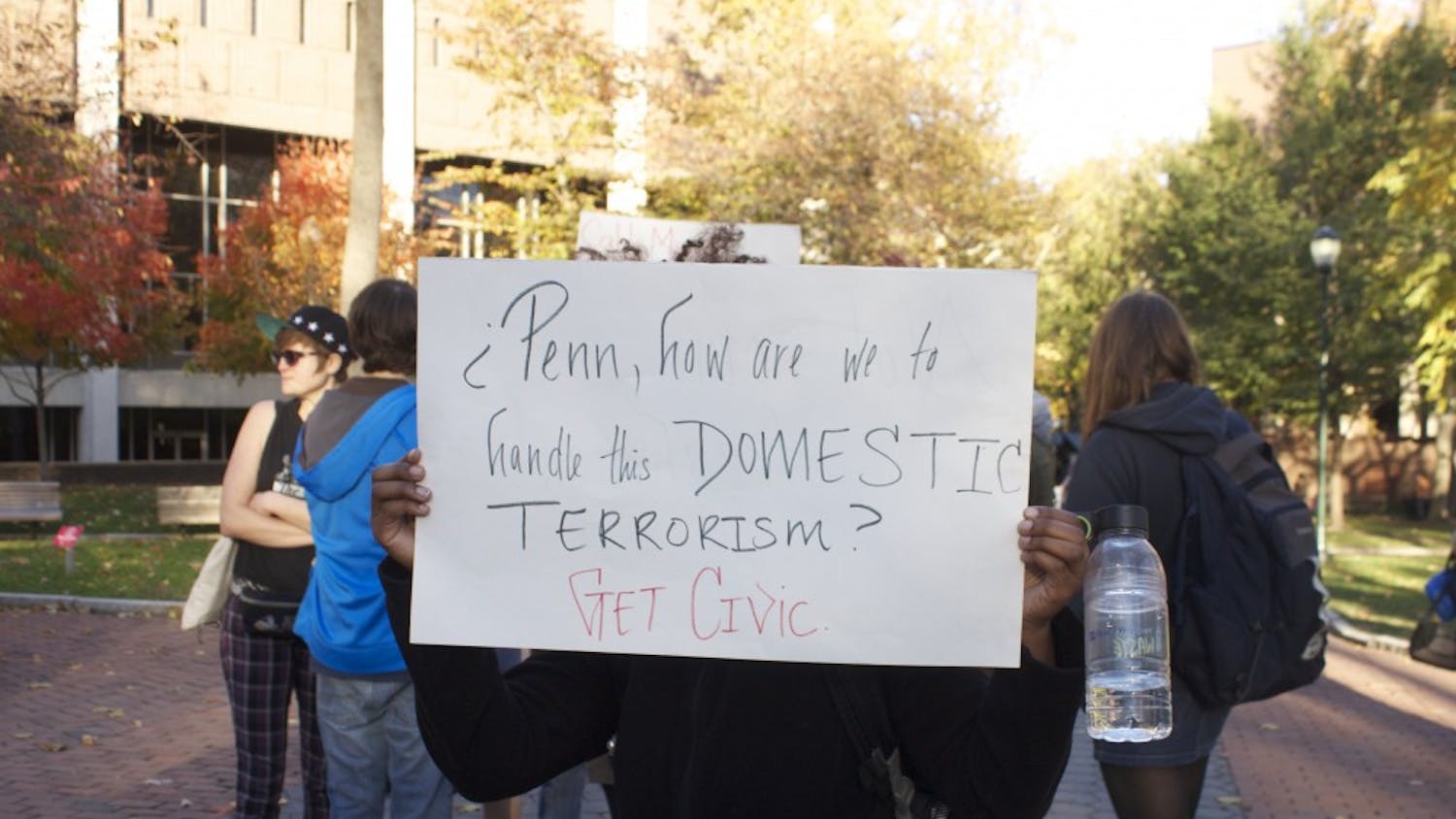 Outside Van Pelt Library, students held signs and spoke in protest of racist GroupMe messages.