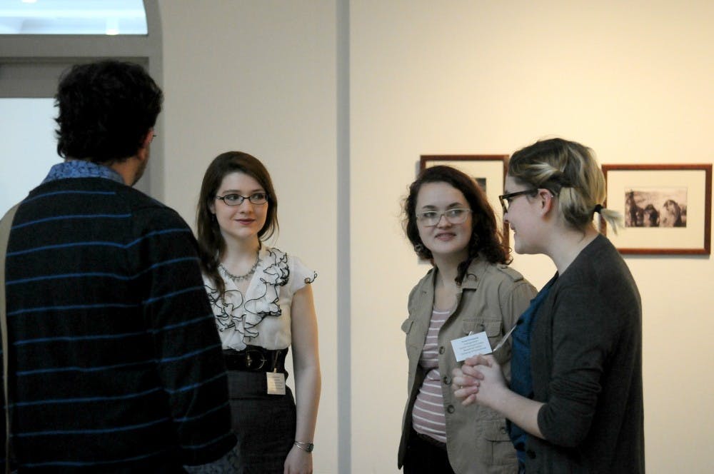 Undergraduates Monica Fenton, Sarah Parkinson, and Ashley Terry, who served as Assistant Student Curators for the exhibit, talked about their work with a visitor.