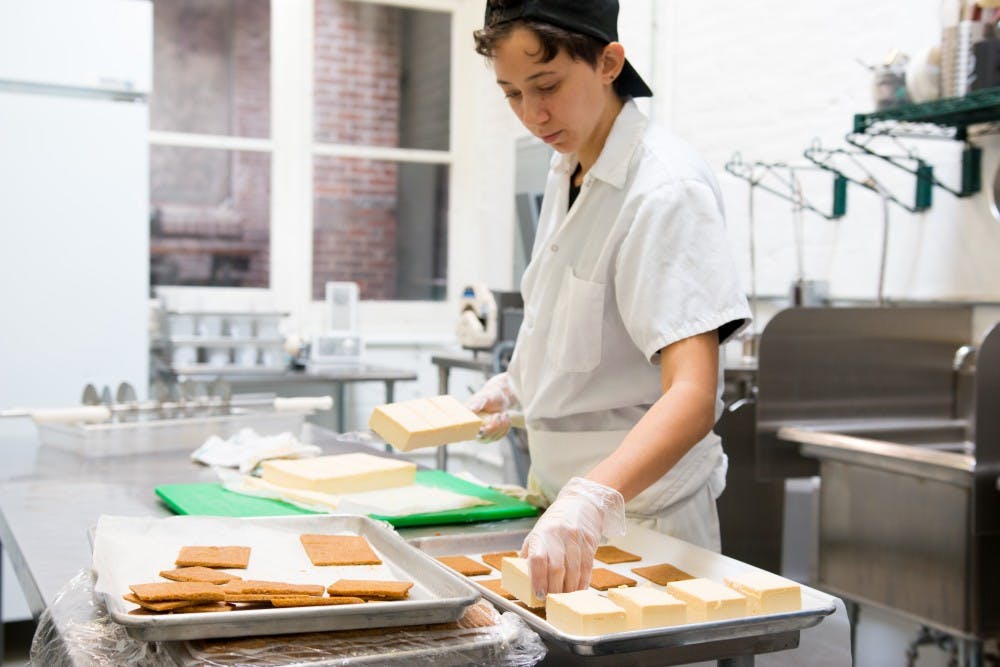 A Weckerley's worker prepares their signature Ice Cream Sandwiches to be packaged and frozen for delivery. 