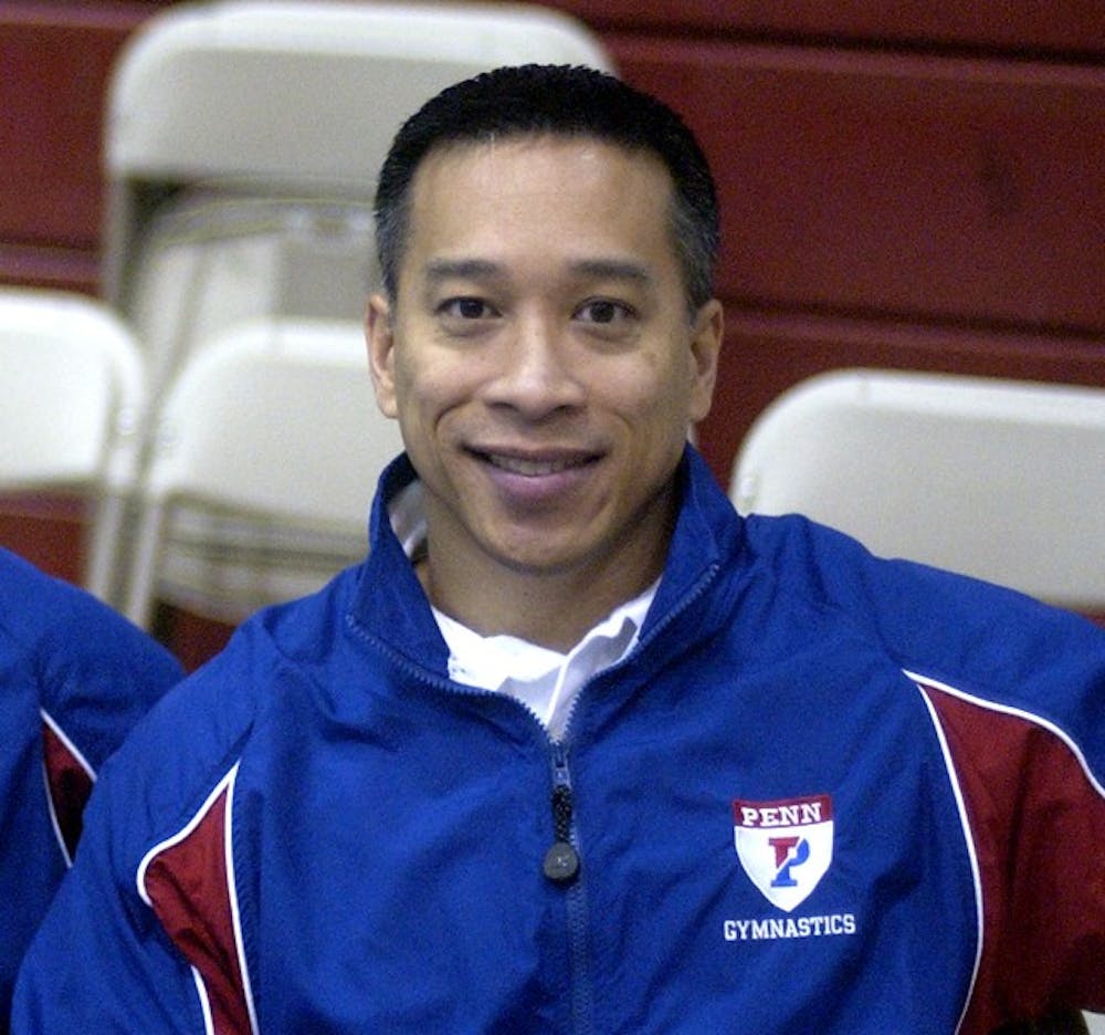 Women's gymnastics wins a meet against Temple University. Head Coach Tom Kovic(L) sits with assistant coach John Cerade(R).