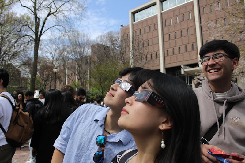 Thousands of Penn affiliates, interim president marvel at solar eclipse — despite clouds over campus