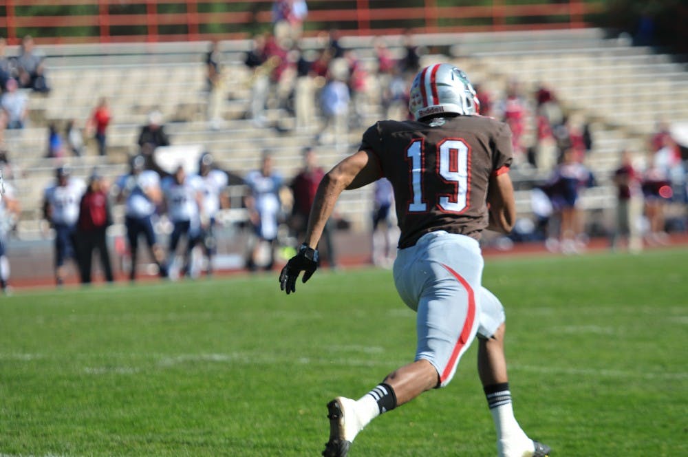 	Brown running back John Spooney runs away from Penn defenders en route to scoring a 93-yard touchdown on the Bears’ first play from scrimmage. Spooney ran for 236 yards on 16 carries as Brown dominated Penn, 27-0.