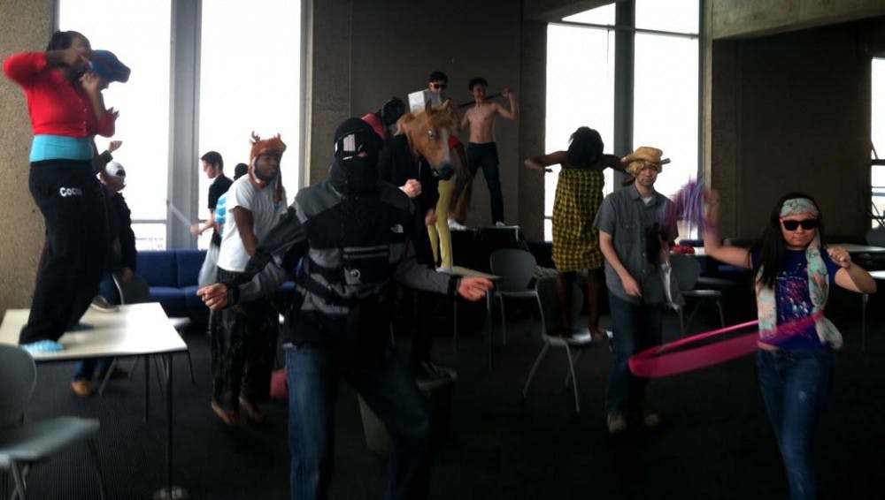 	A group of students dance in Harrison College House’s Heyer Sky Lounge on Saturday to create their version of a Harlem Shake video.