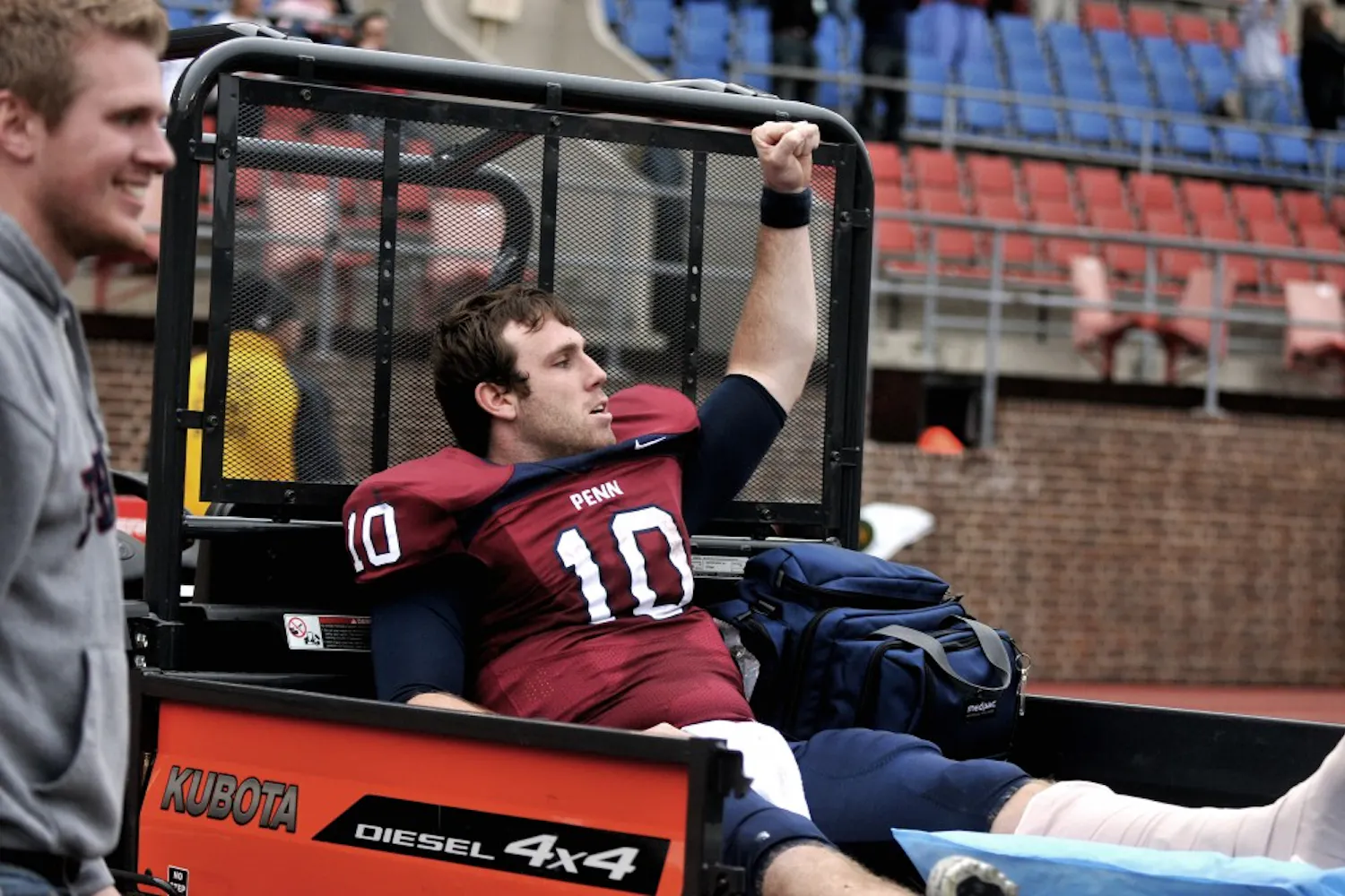 Senior quarterback Billy Ragone celebrated the end of Penn’s victory from a Gator on the sidelines after dislocating his ankle at the end of the third quarter Saturday. Andrew Holland will start in his place next week at Cornell.