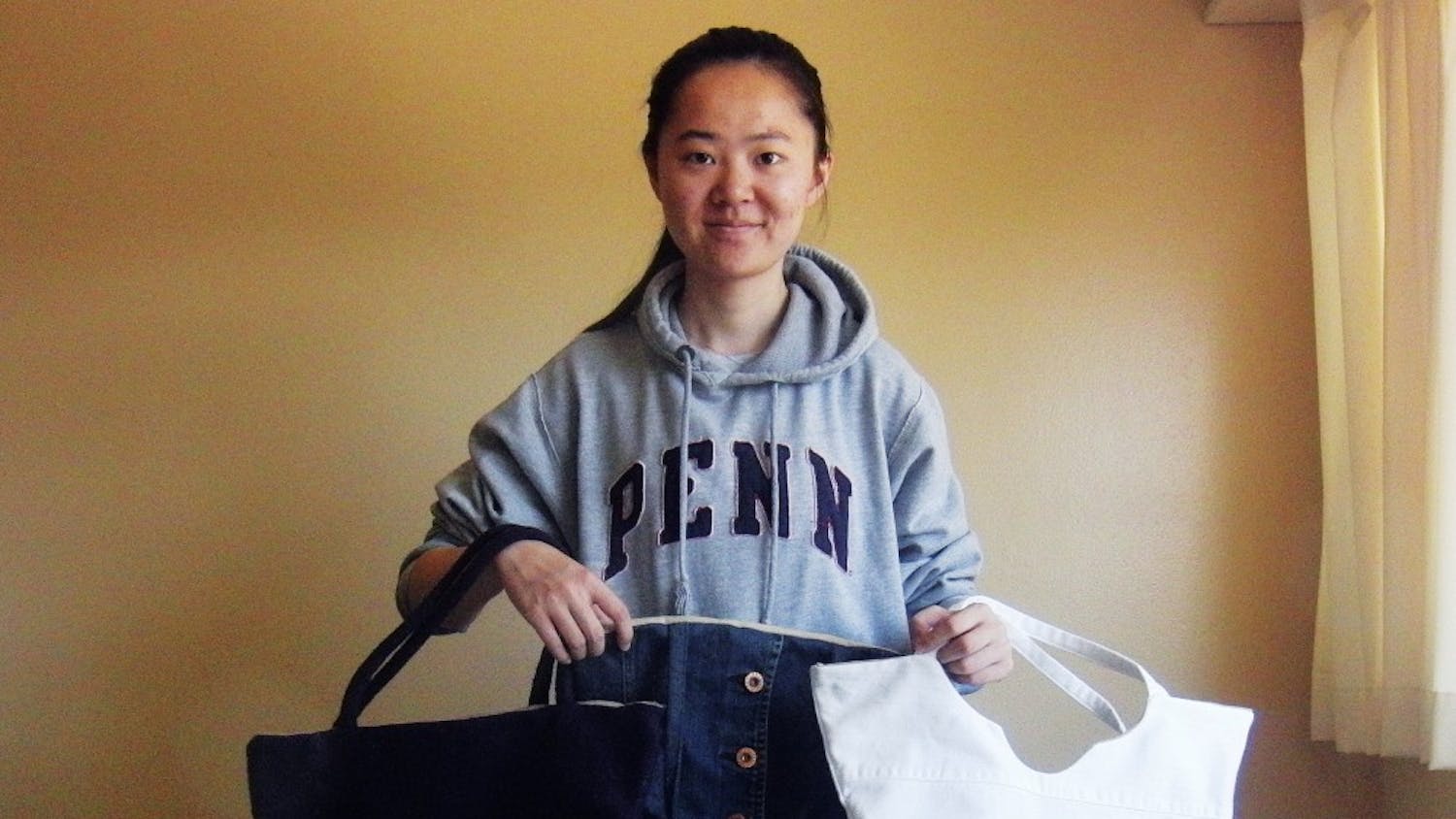 College senior Yi Wang shows off some of ReBag's products.