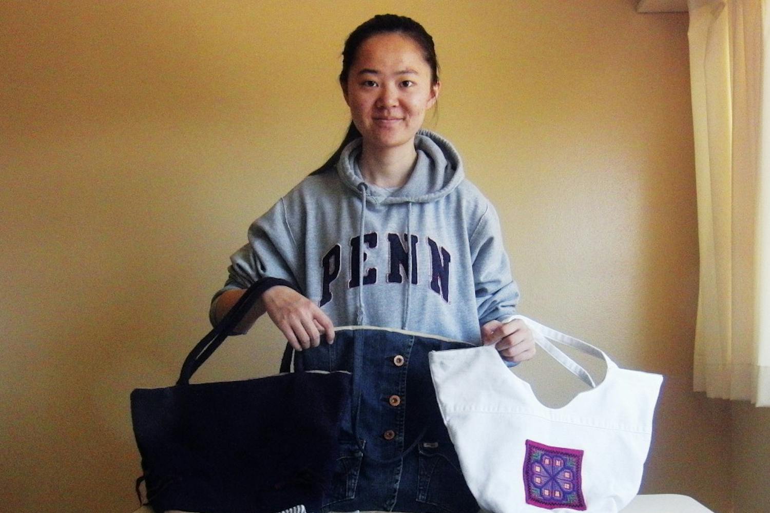 College senior Yi Wang shows off some of ReBag's products.