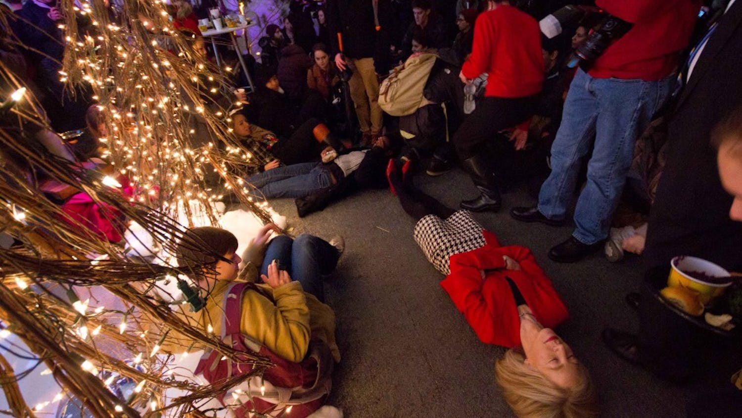 President Amy Gutmann participating in a "die in" at her annual Christmas party.