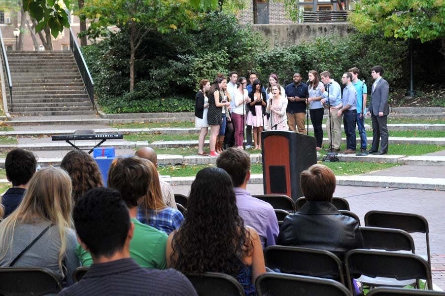 Friends and family hold a memorial service for Alex Moll on College Green