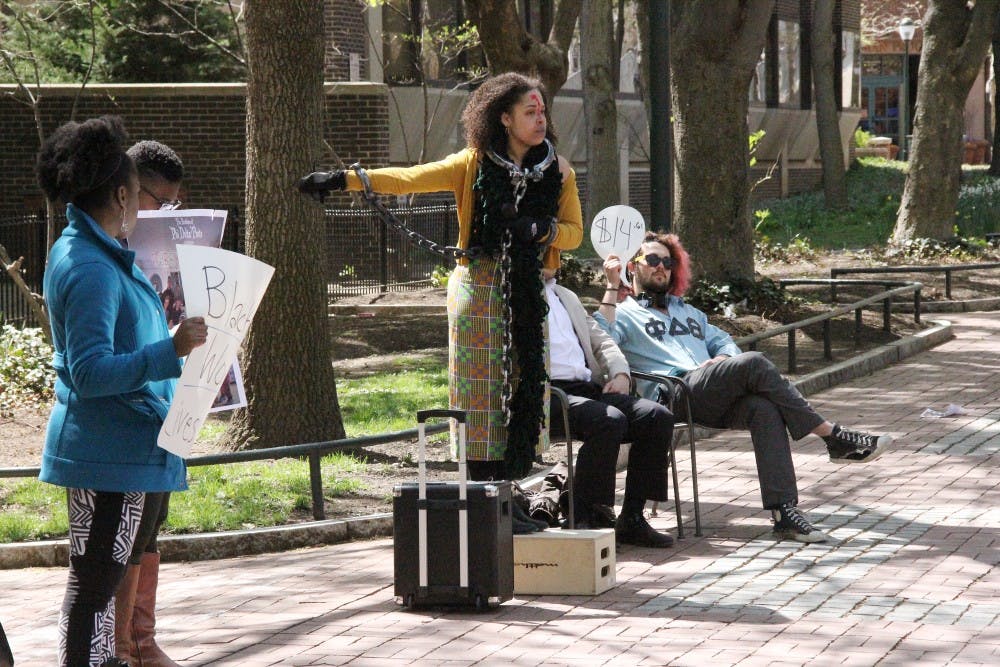 A member of SOUL recited a poem in front of the Phi Delta Theta chapter house on Locust Walk.