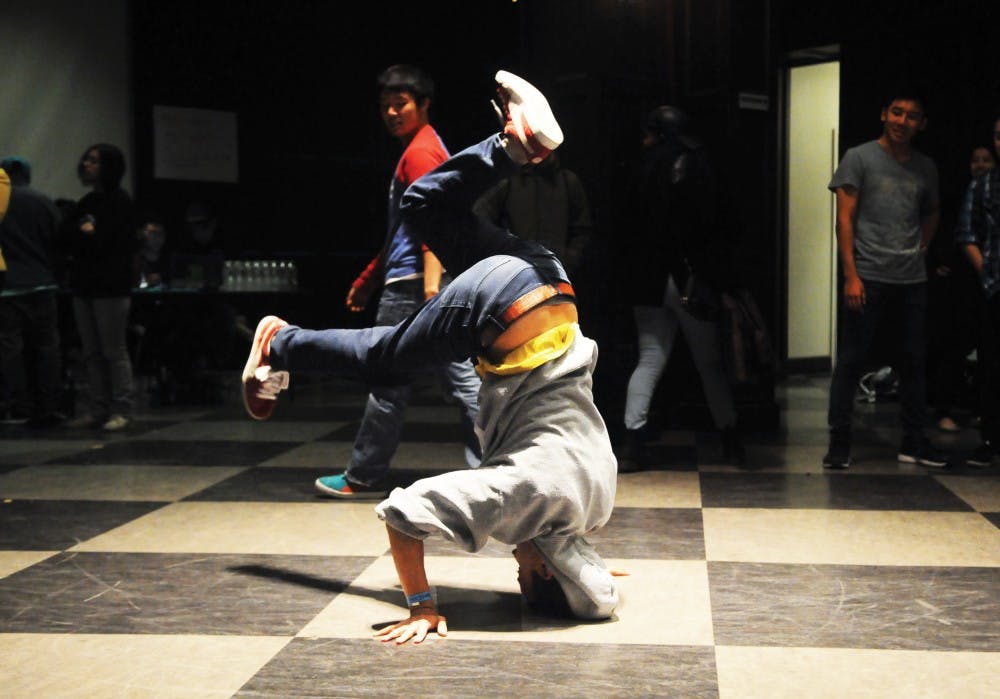 Students warm up and compete at Rhythmic Damage IX, a breakdance tour and competition featuring team and individual battles.