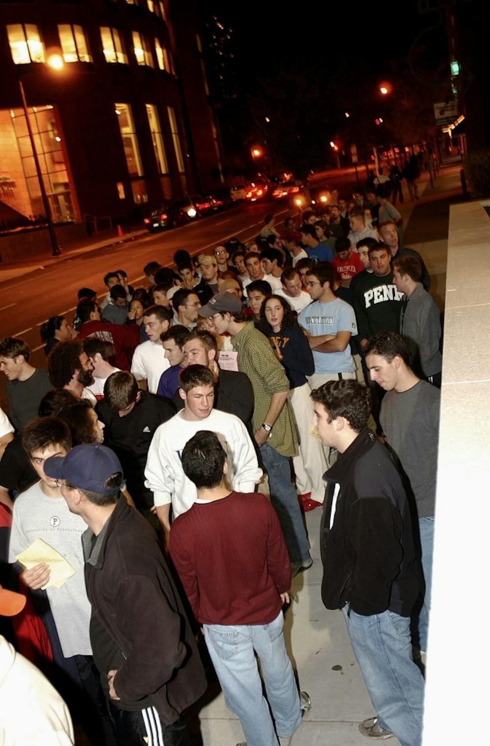 Hundreds of Penn fans anxiously wait for an opportunity to receive bracelets to buy season basketball tickets.  The location and time of the event wasn't announced until moments before the actual bracelets were given out.