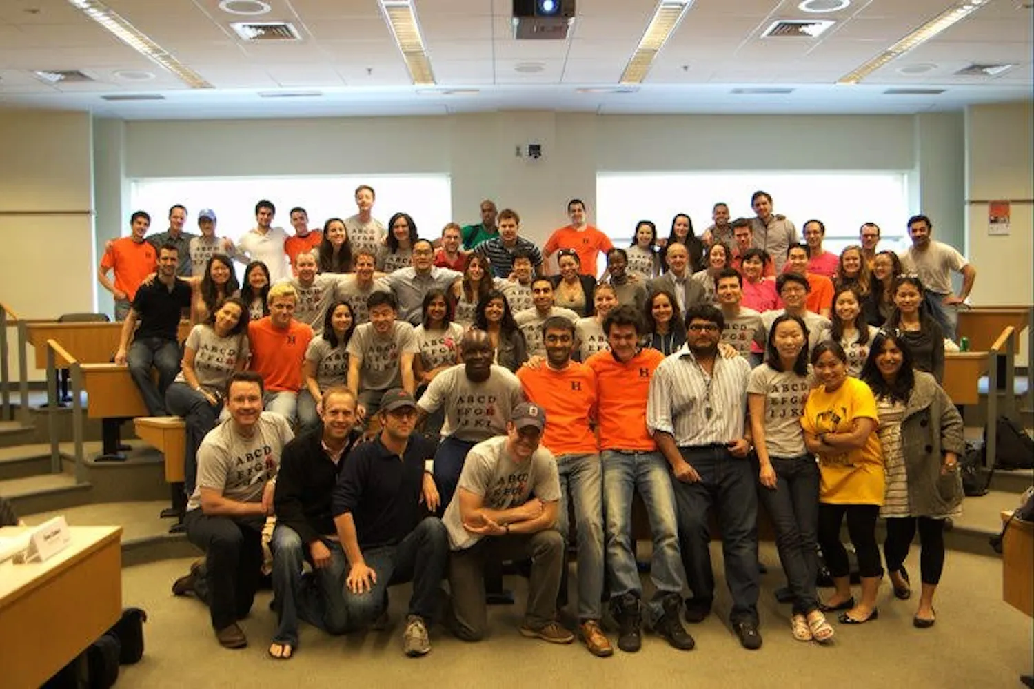 Cohort H from the Wharton MBA class of 2011 poses for a photo. Evan McMullin is visible in the grey blazer three rows back, sixth from the right. Tony Altimore is in the center back, wearing a dark blue striped polo. Evan McMullin ran for president as a “never Trump” independent on a platform of “principled, conservative leadership.”