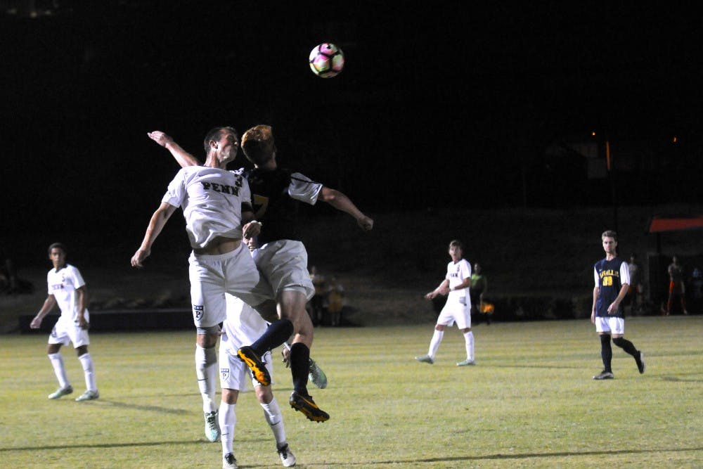 Junior right back Sam Wancowicz fights a La Salle player for a header.