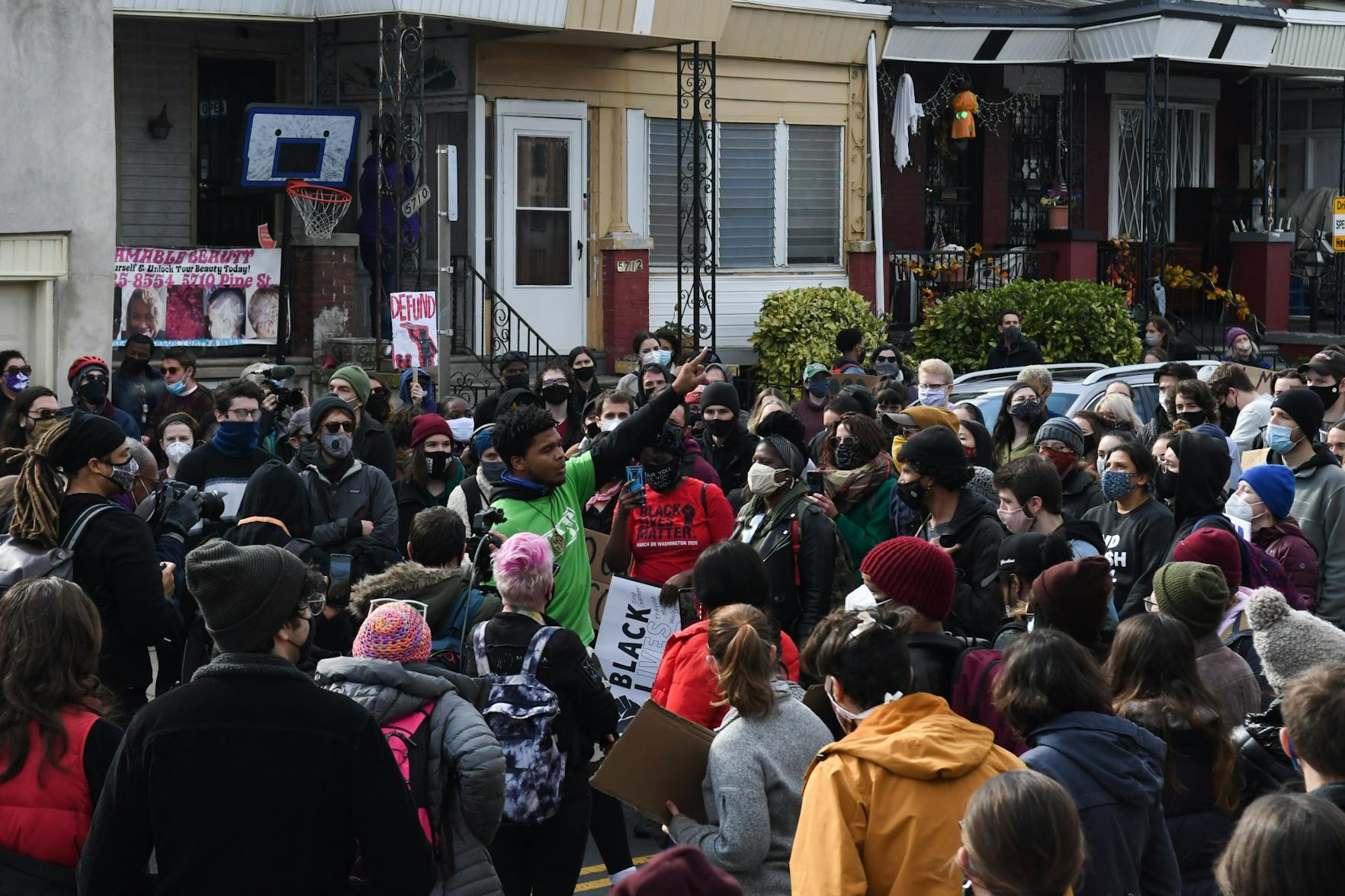 10-31-20 Walter Wallace Day 2 West Philadelphia Protest Speaker in Middle Crowd Fist Up.jpg