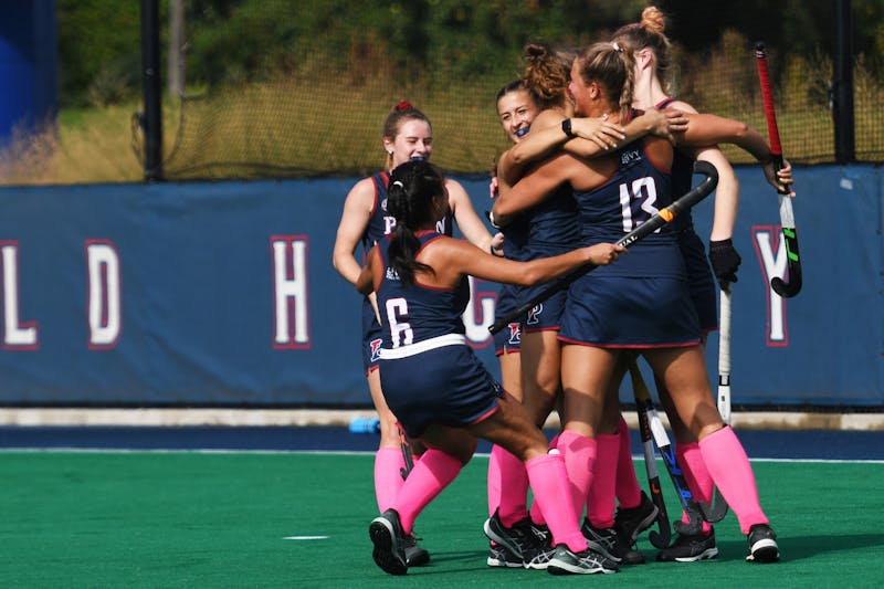 Field hockey players pause to 'support breast cancer awareness' at a recent  game 