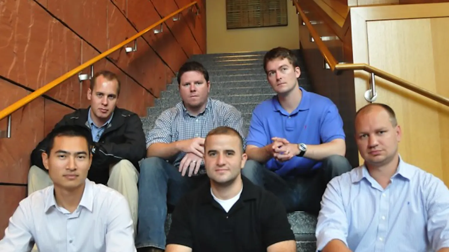 Wharton Student War Veterans sit on the steps of Huntsman Hall