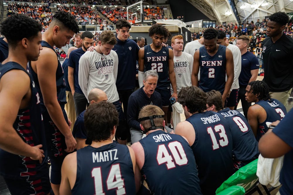 03-11-23-mens-basketball-vs-princeton-team-huddle-anna-vazhaeparambil-01